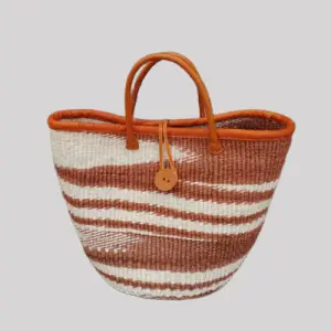 Handmade African woven basket bag with brown and white patterns and leather handles